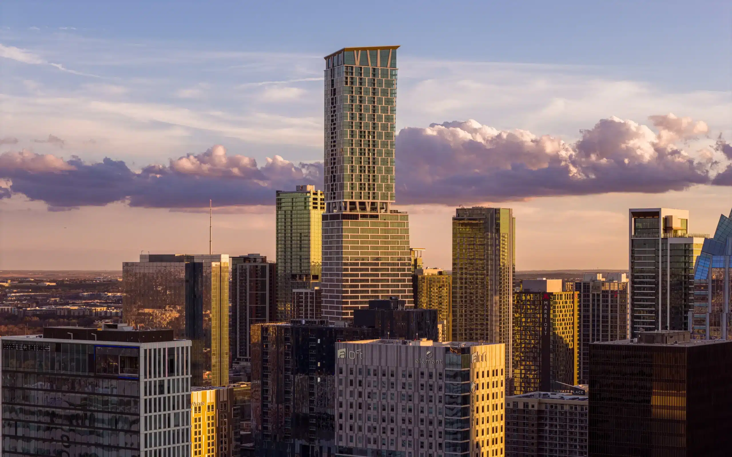 Waterline tower rising above the downtown Austin skyline at sunset