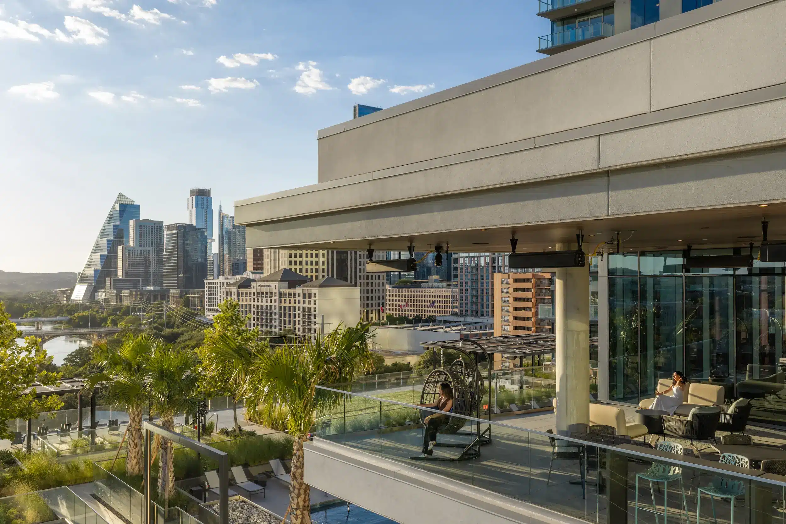 The Travis ATX outdoor lounge terrace with planting and city views