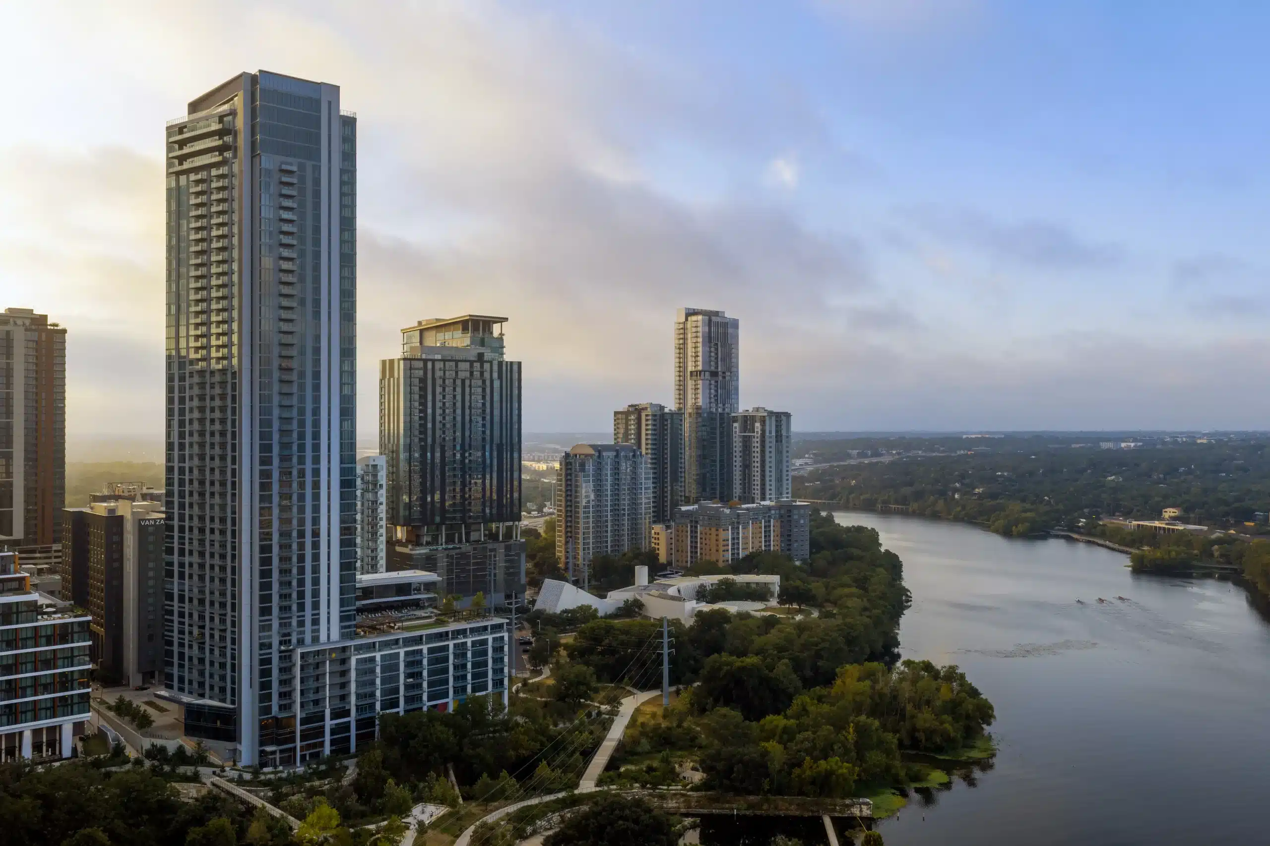 The Travis ATX tower overlooking Lady Bird Lake and surrounding buildings