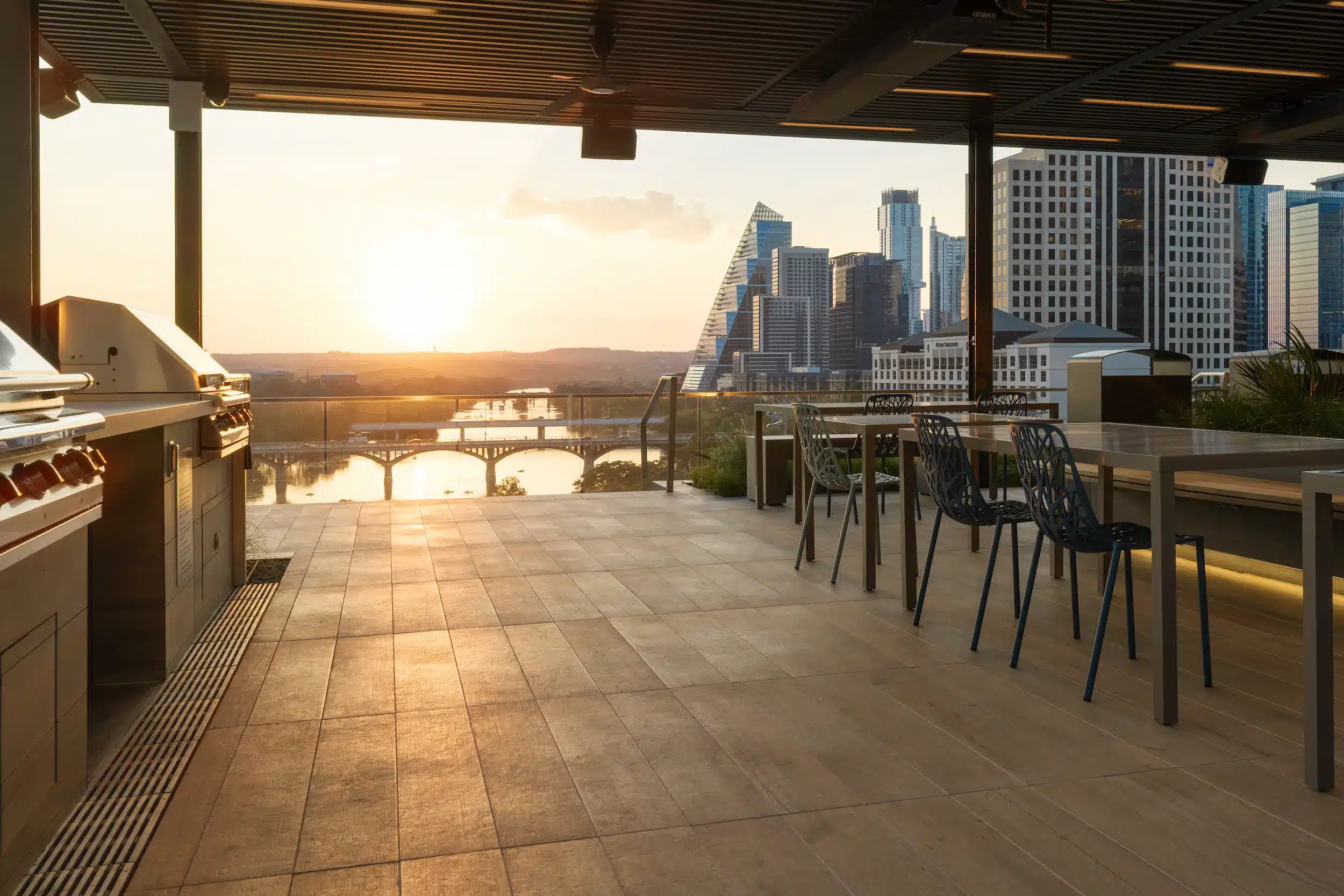Outdoor kitchen and dining terrace at The Travis ATX at sunset
